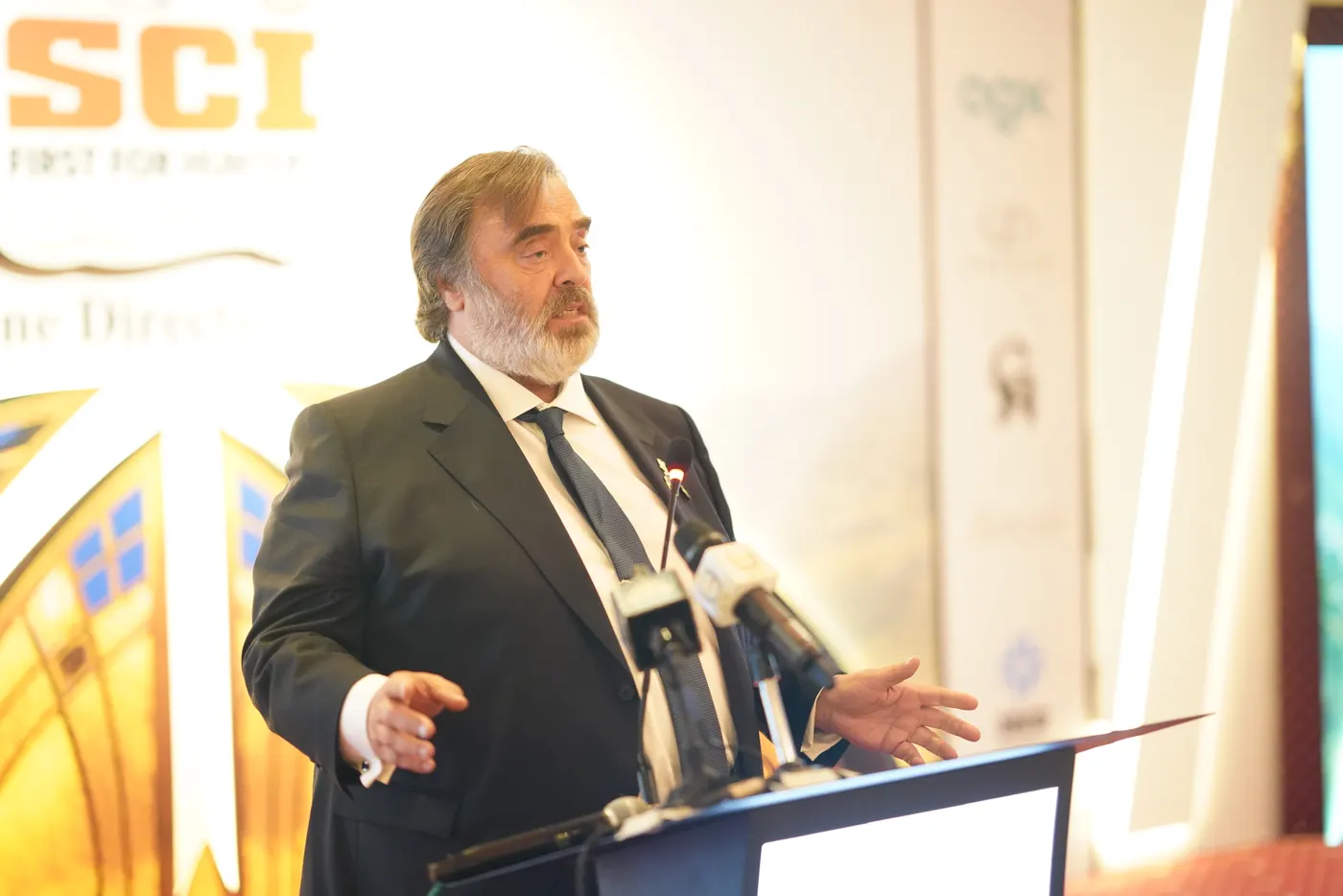 A speaker gestures from the lectern during the conference.