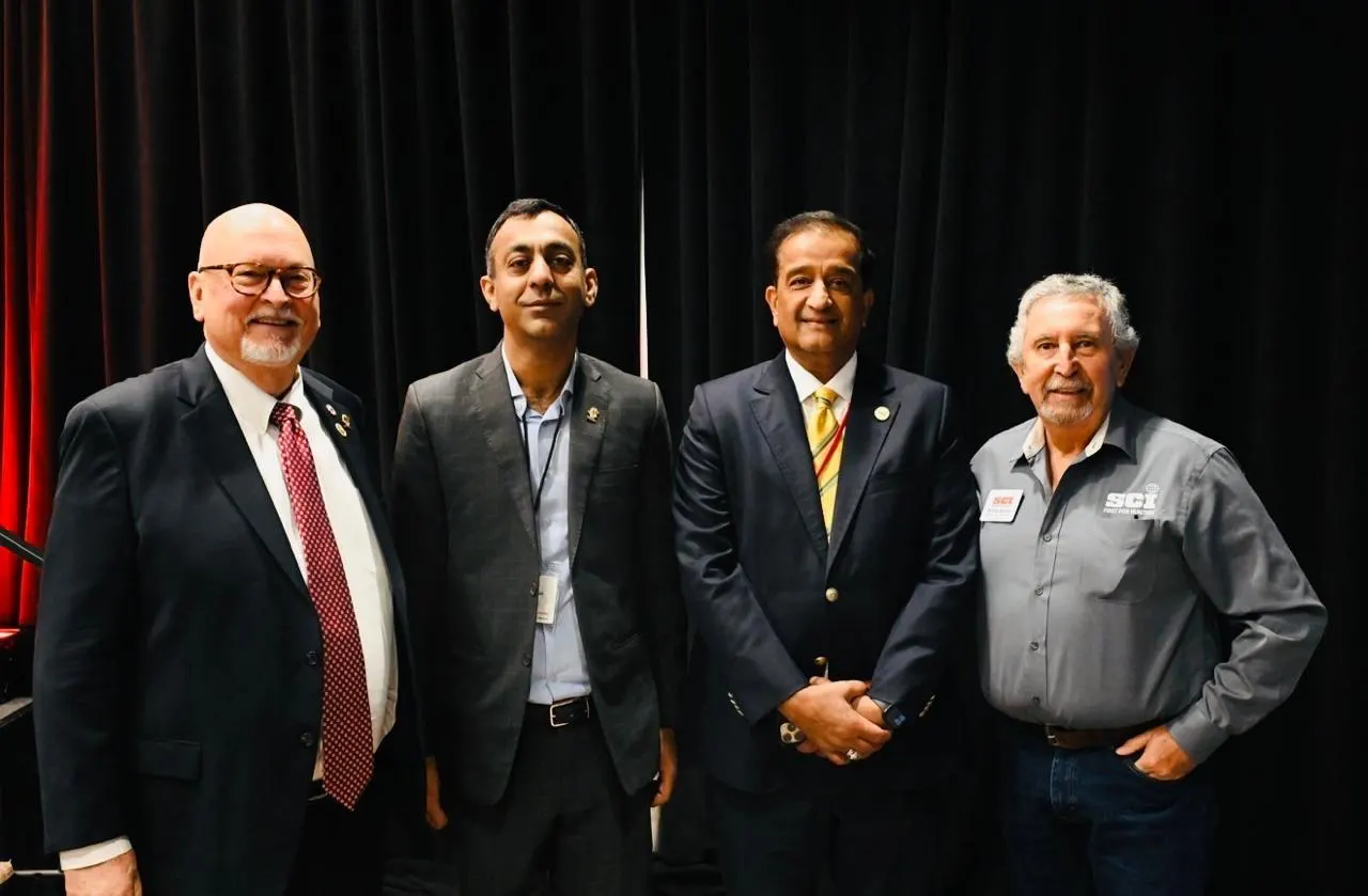 Chapter representatives stand with SCI members at an international leadership forum.