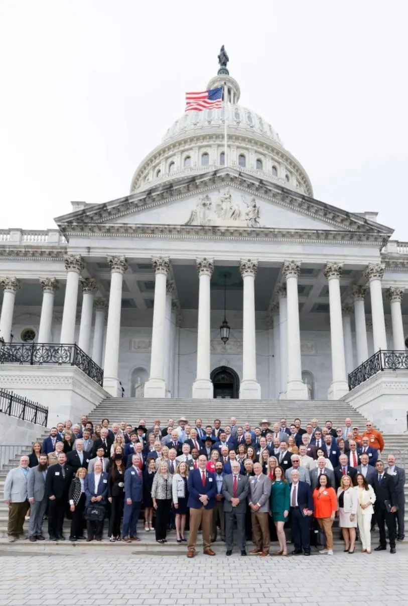 SCI members gather on the steps beneath the dome of the United States Capitol.
