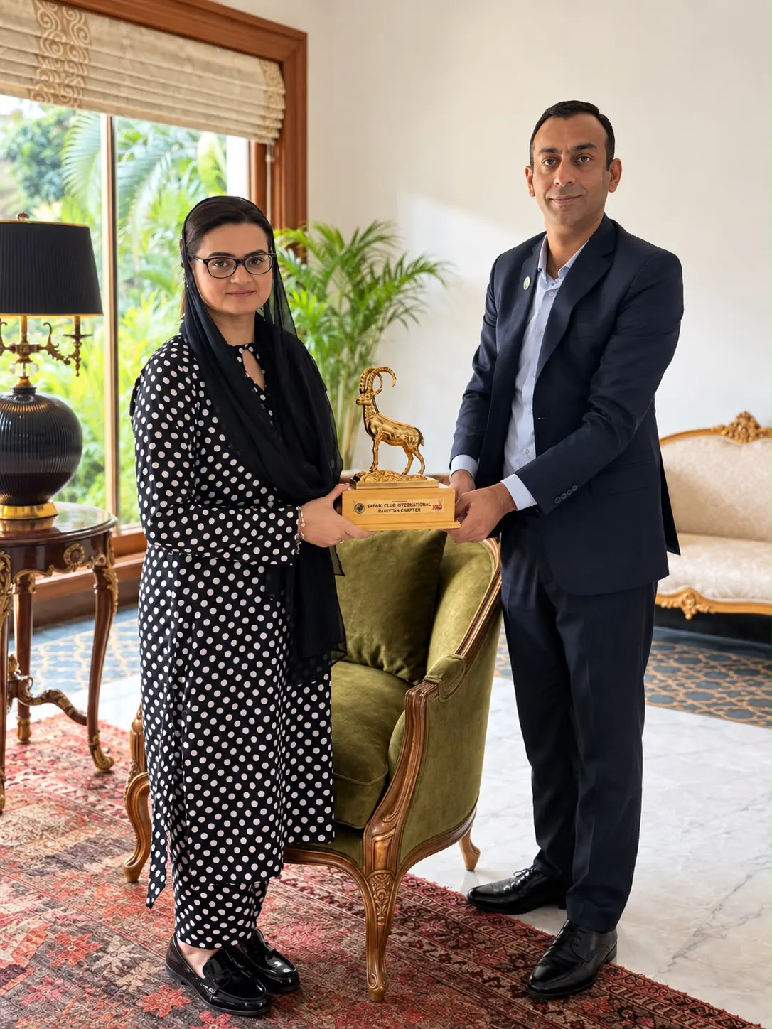Maryam Aurangzeb and a chapter representative hold a gold markhor award from the Safari Club International Pakistan Chapter.